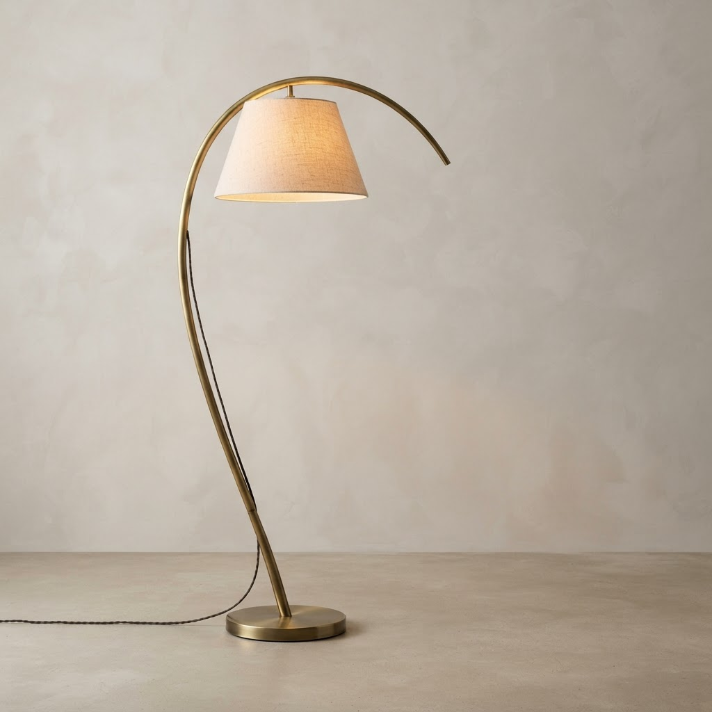 Sculptural brass arc floor lamp with linen shade
